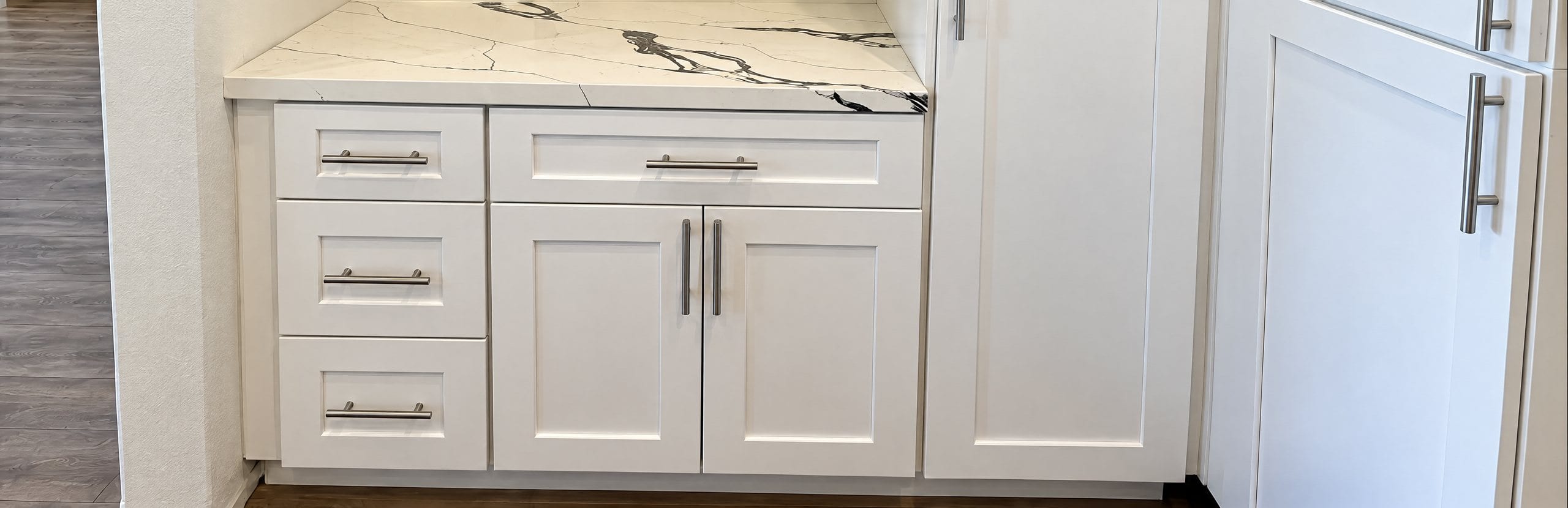 White shaker cabinet drawers fitted with new bar pulls