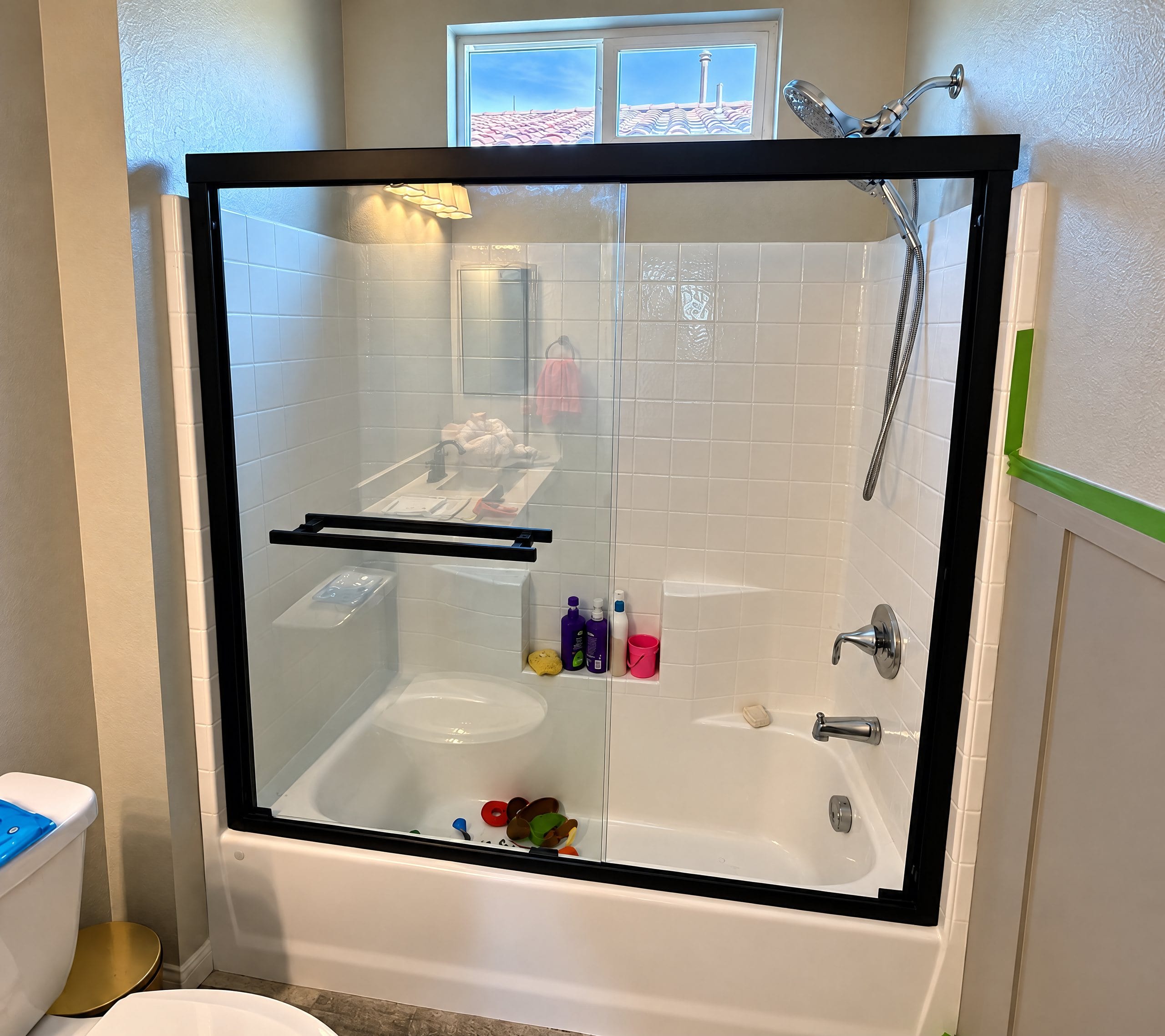 Framed sliding shower door installed over a tub