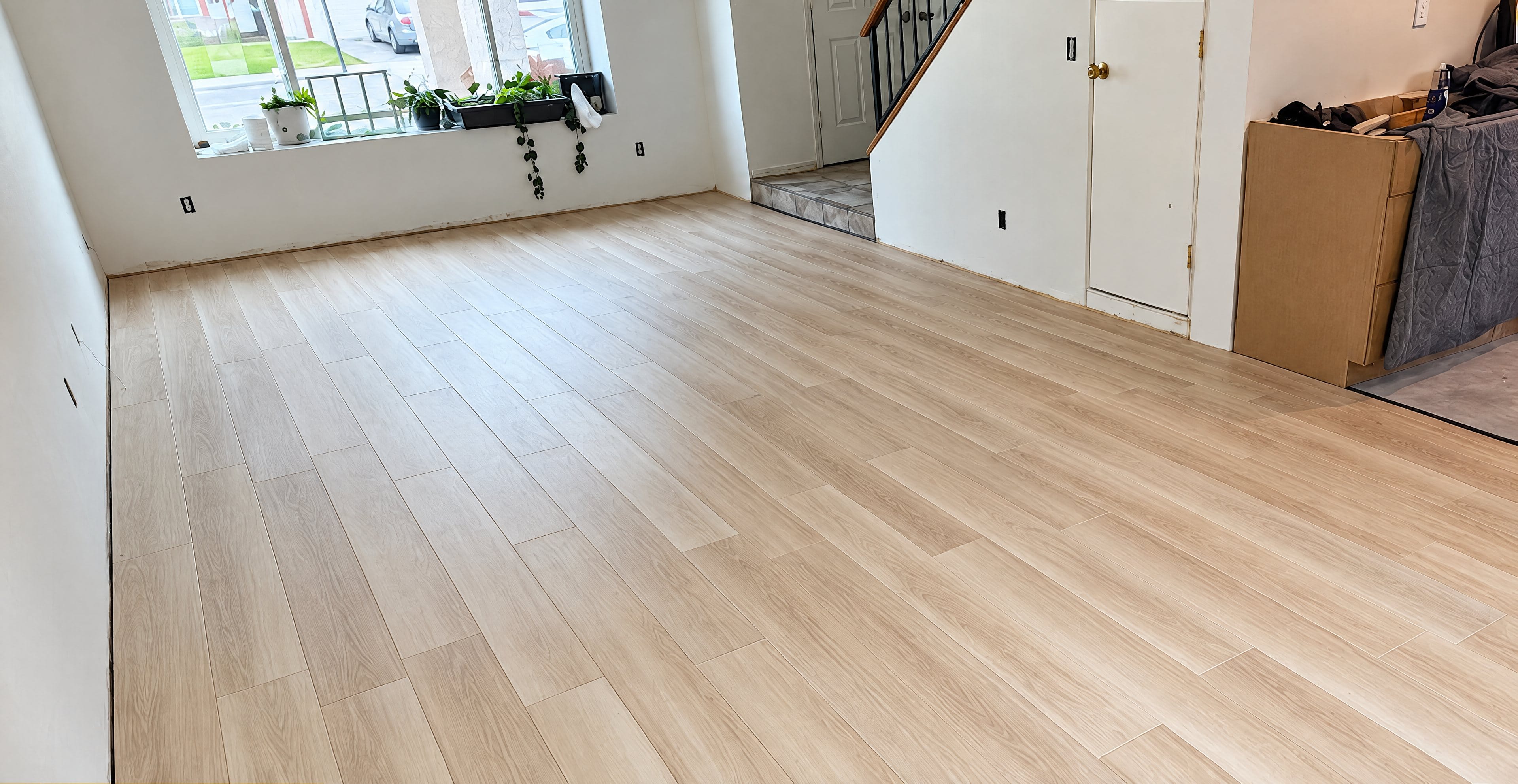 Open living area with new light plank flooring
