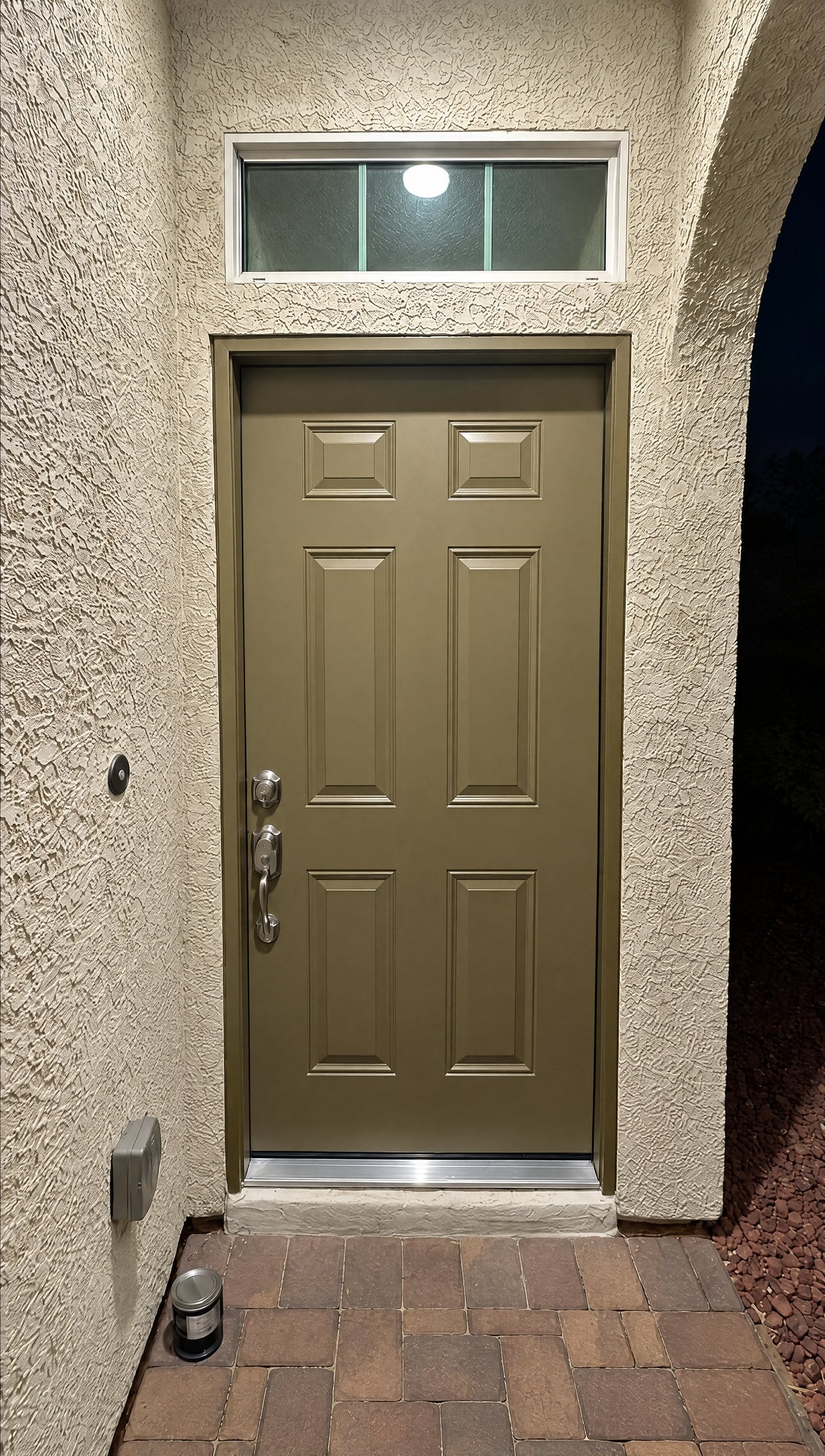 New exterior front door installed in a stucco entryway