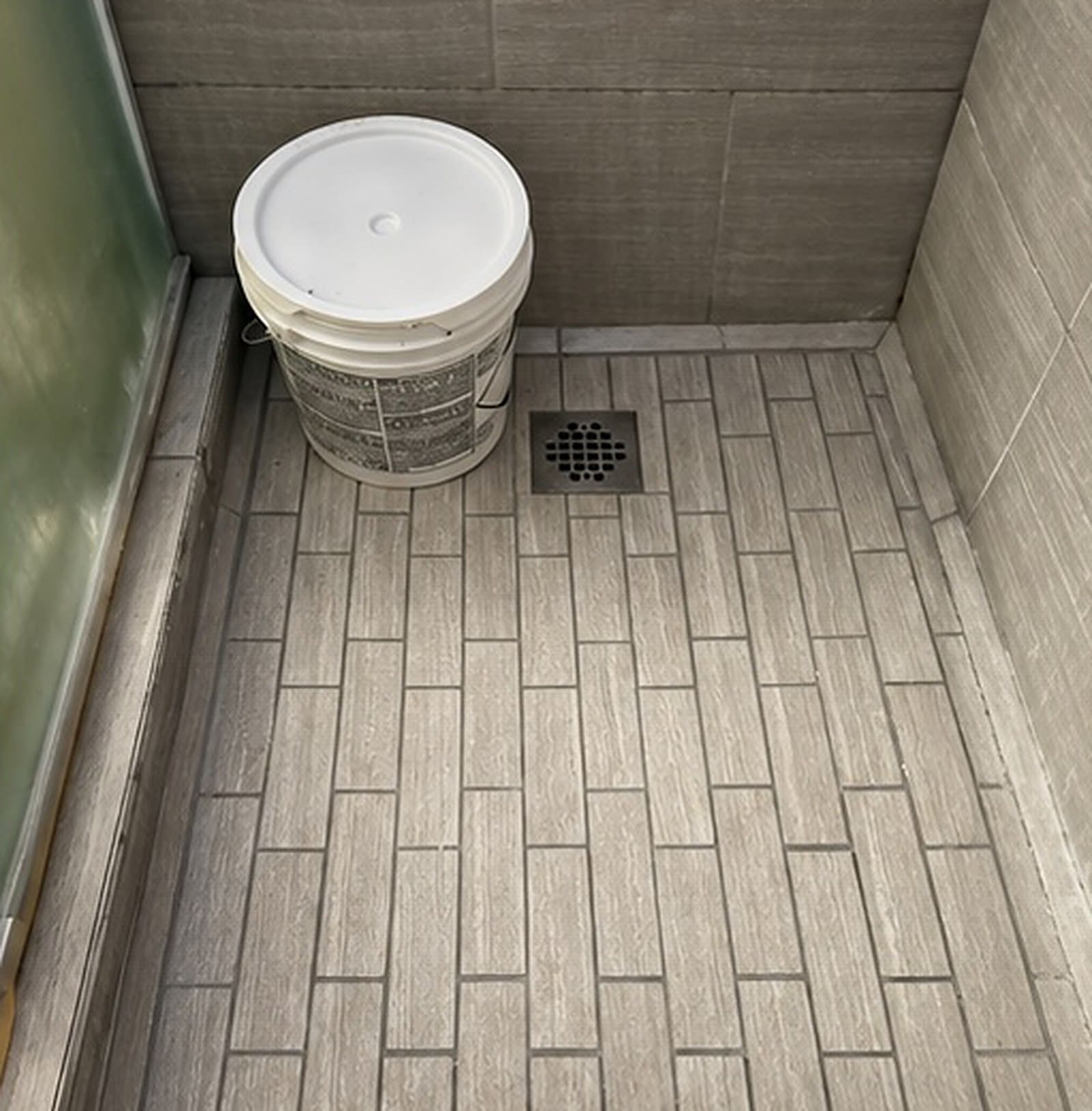 Shower floor rebuilt and finished in plank tile